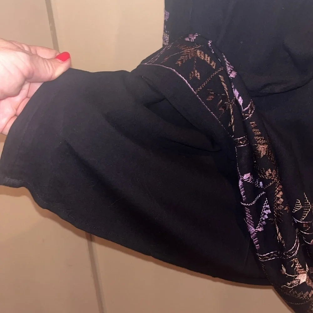 Free People black mini dress size XS with back tie and deep V bk w/ embroidery